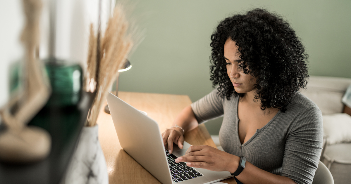 Person sitting at a desk and looking at a computer